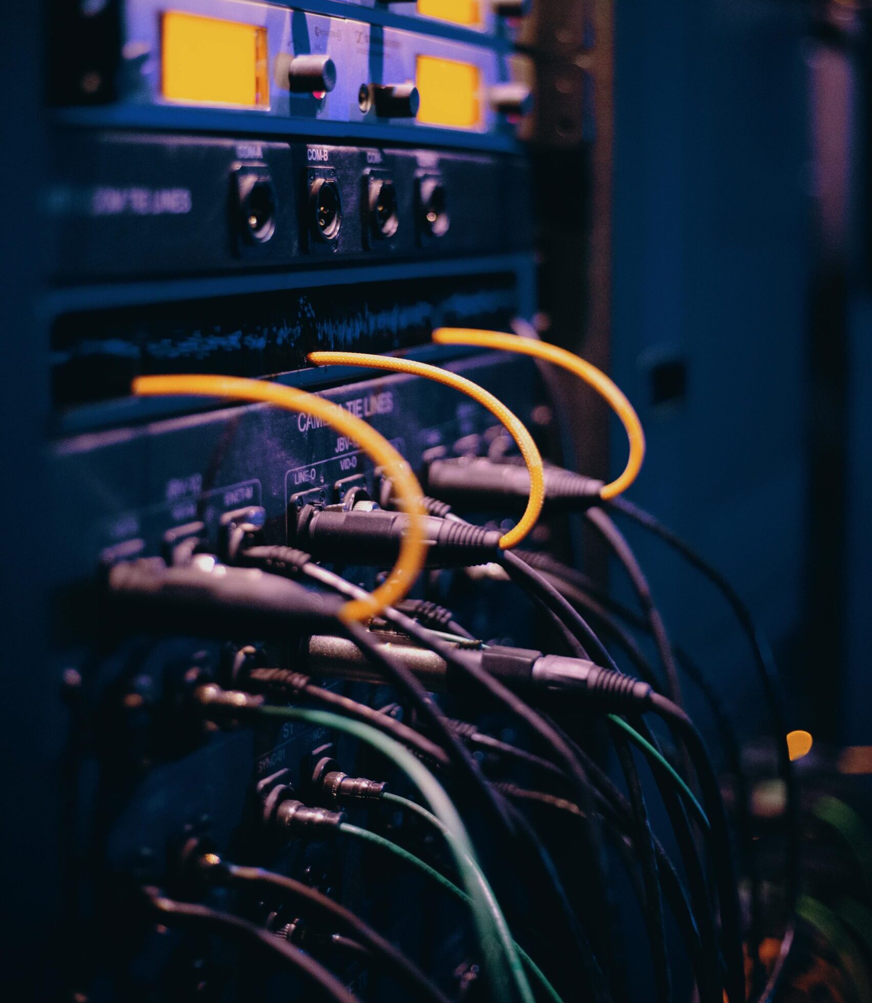 Close-up of network cables and ports in a server rack, showcasing connectivity.